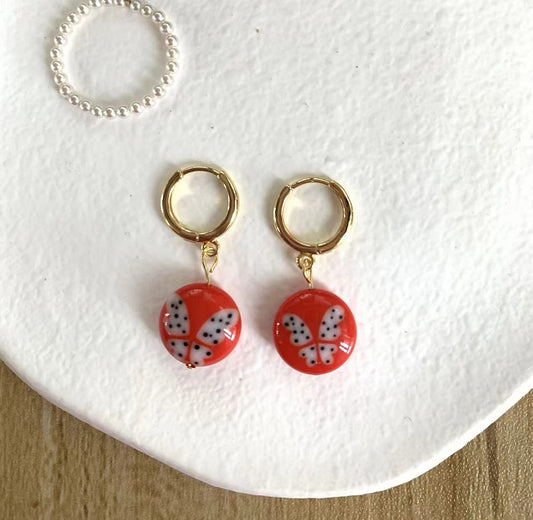 Red butterfly disc earrings